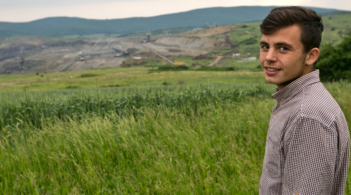 Armend Grajcevci, 15, stands at the edge of Hade, his village in central Kosovo