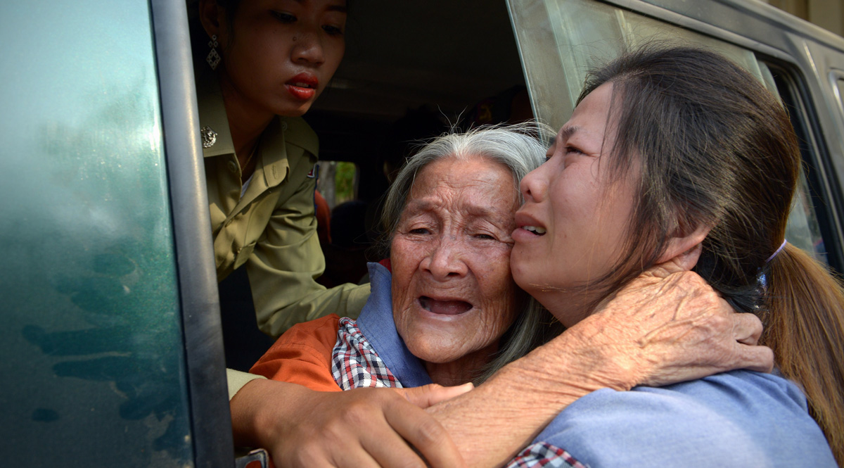 Cambodian land rights activist Nget Khun, known locally as 'Mommy', hugs her daughter through a window of a prison car at the Appeal Court in Phnom Penh in January this year