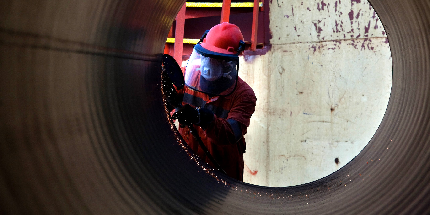 A worker inspects a Saipem gas pipe