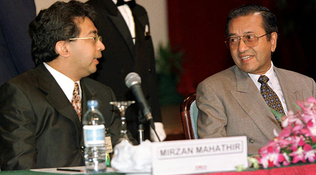 Then-Malaysian Prime Minister Mahathir Mohamad (right) with his son Mirzan Mahathir at the 1997 ASEAN summit