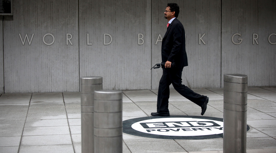 A man walks by the entrance to the World Bank Group headquarters in Washington, DC