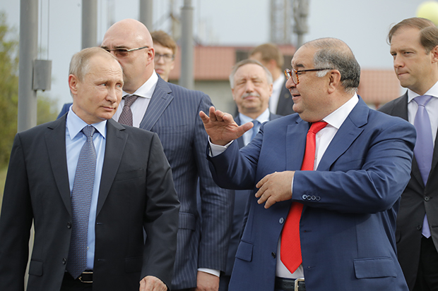 Russian billionaire Alisher Usmanov and Vladimir Putin