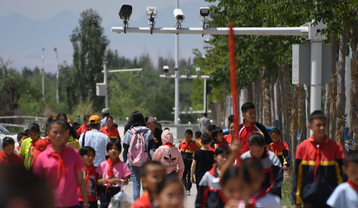 schoolchildren walking below surveillance cameras in Akto, south of Kashgar, in China's western Xinjiang region