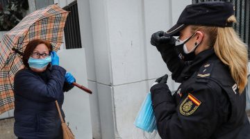 Police give out a face mask in spain