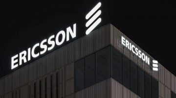 Ericsson sign atop the company's headquarters at night.