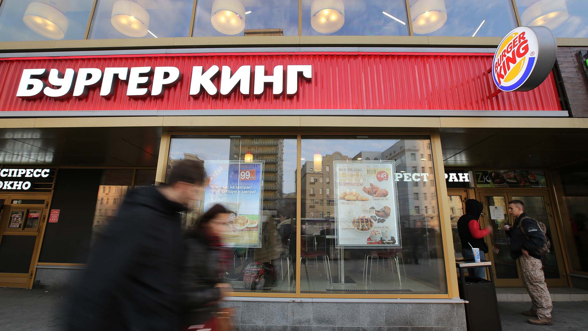 Photo of pedestrians walking past a Burger King in Moscow