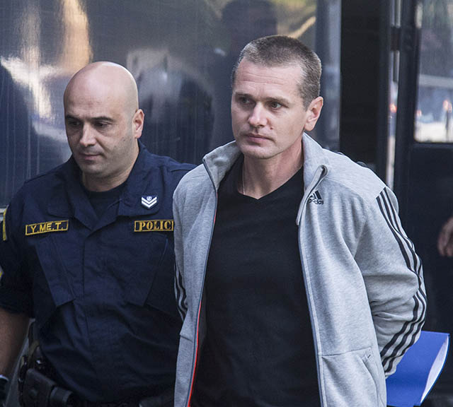 Photo of Alexander Vinnik in custody beside a policeman