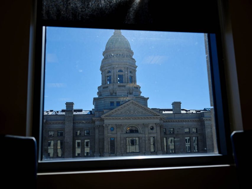 Photo of the Wyoming Capitol building taken through a window