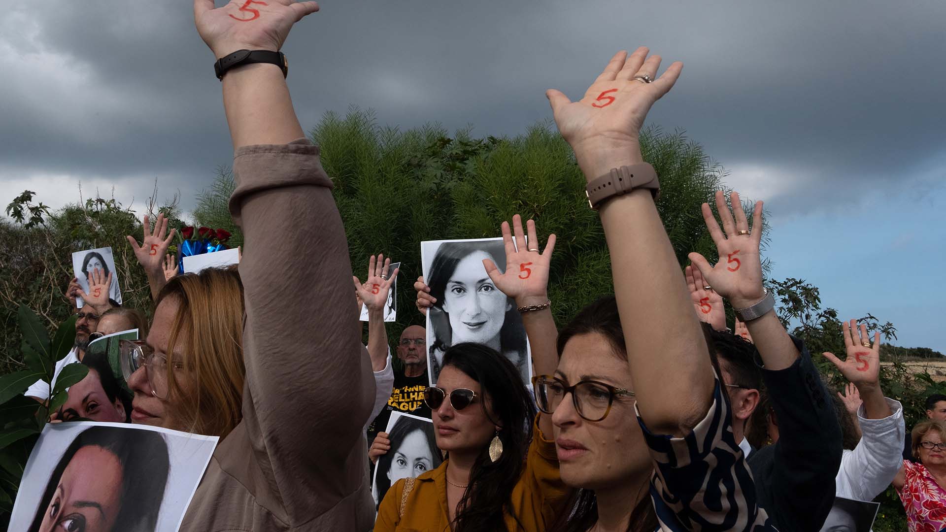 People hold signs for Daphne Caruana Galizia