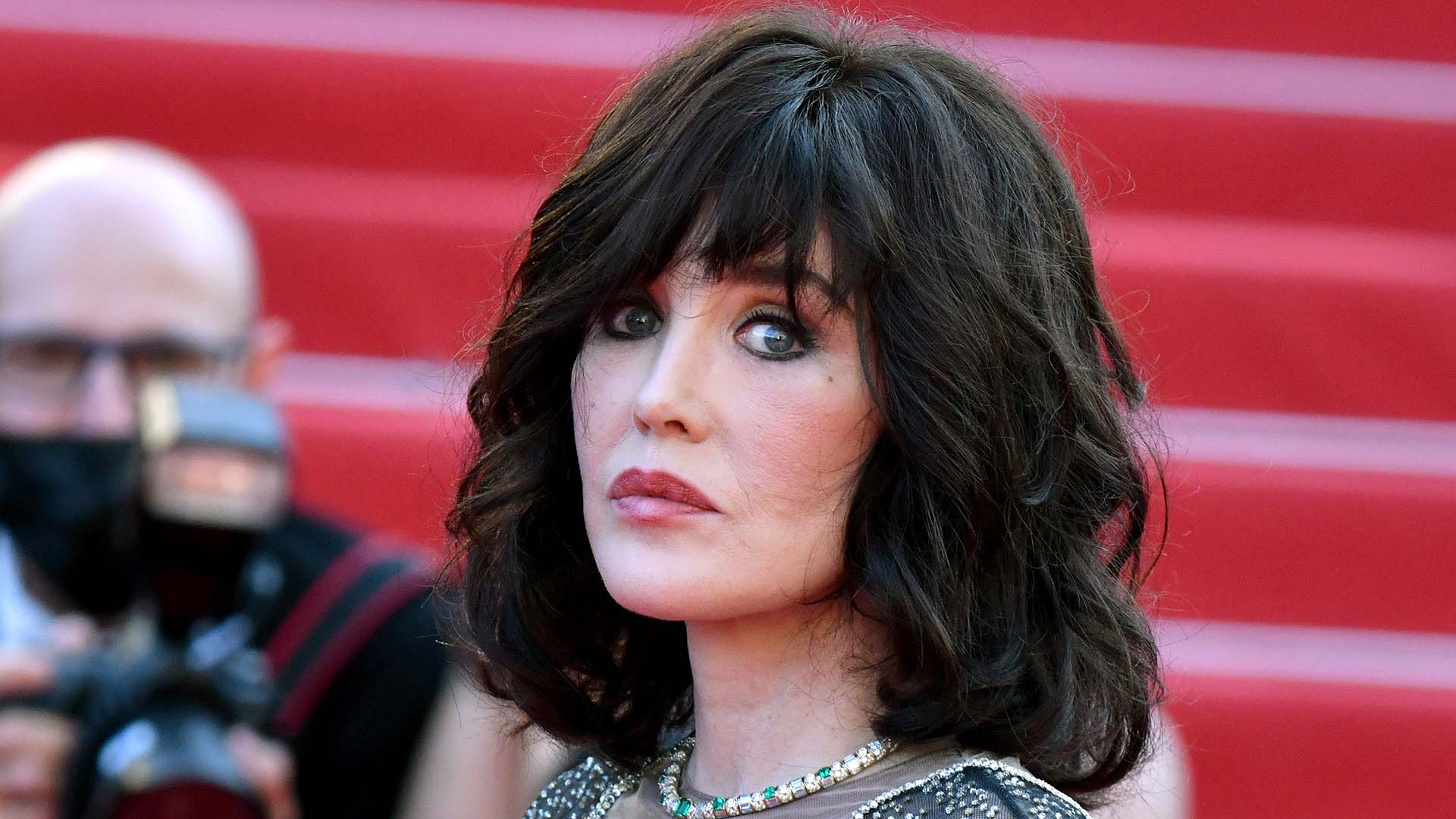 A woman with brown hair being photographed on the red carpet