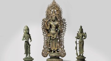 Three 9th or 10th century bronze statues on a white backdrop