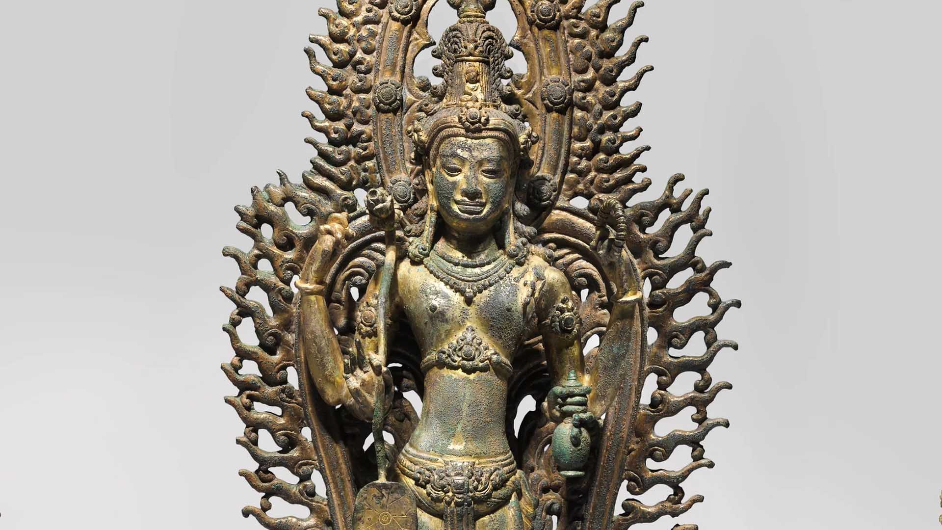 A close-up of a 9th or 10th century bronze statue from Cambodia