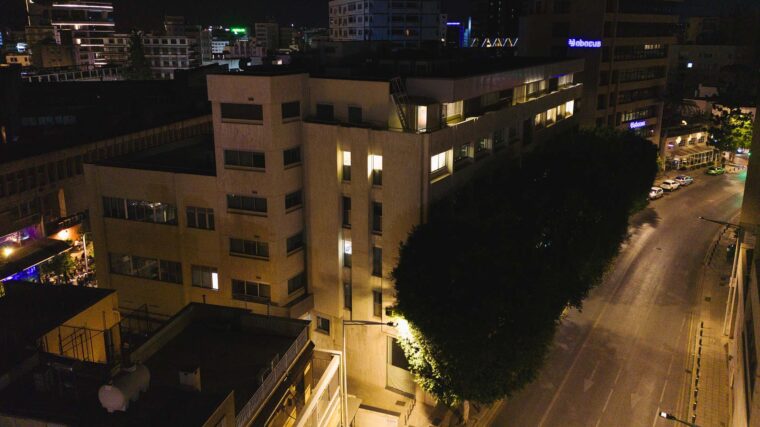 A large white office building at night