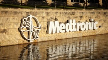 A white Medtronic sign reflected in water