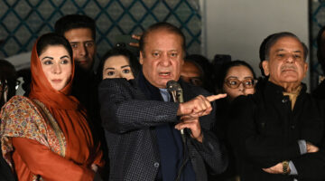 Pakistan's former prime minister stands addresses supporters pointing his finger