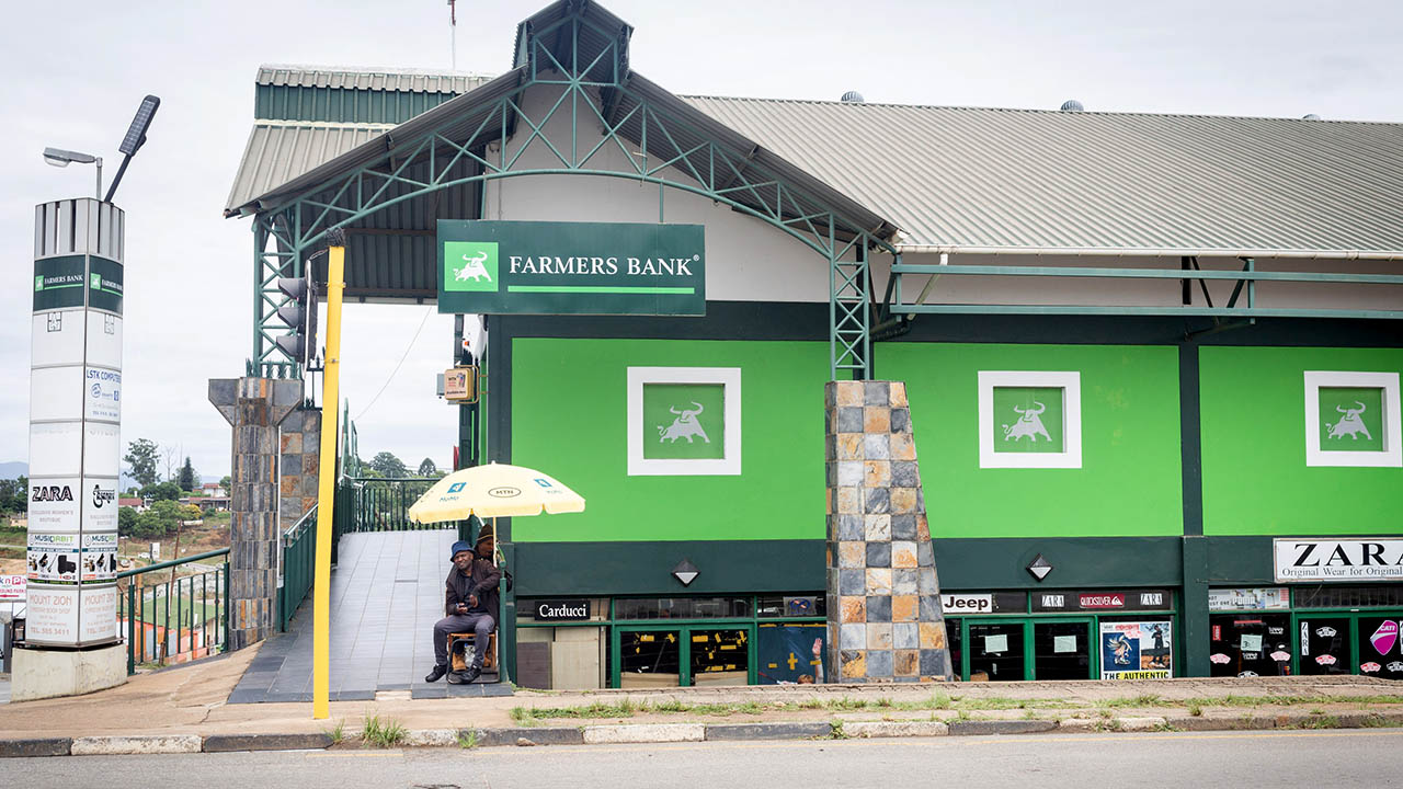 Photo of a green-walled building with a sign that reads Farmers Bank.