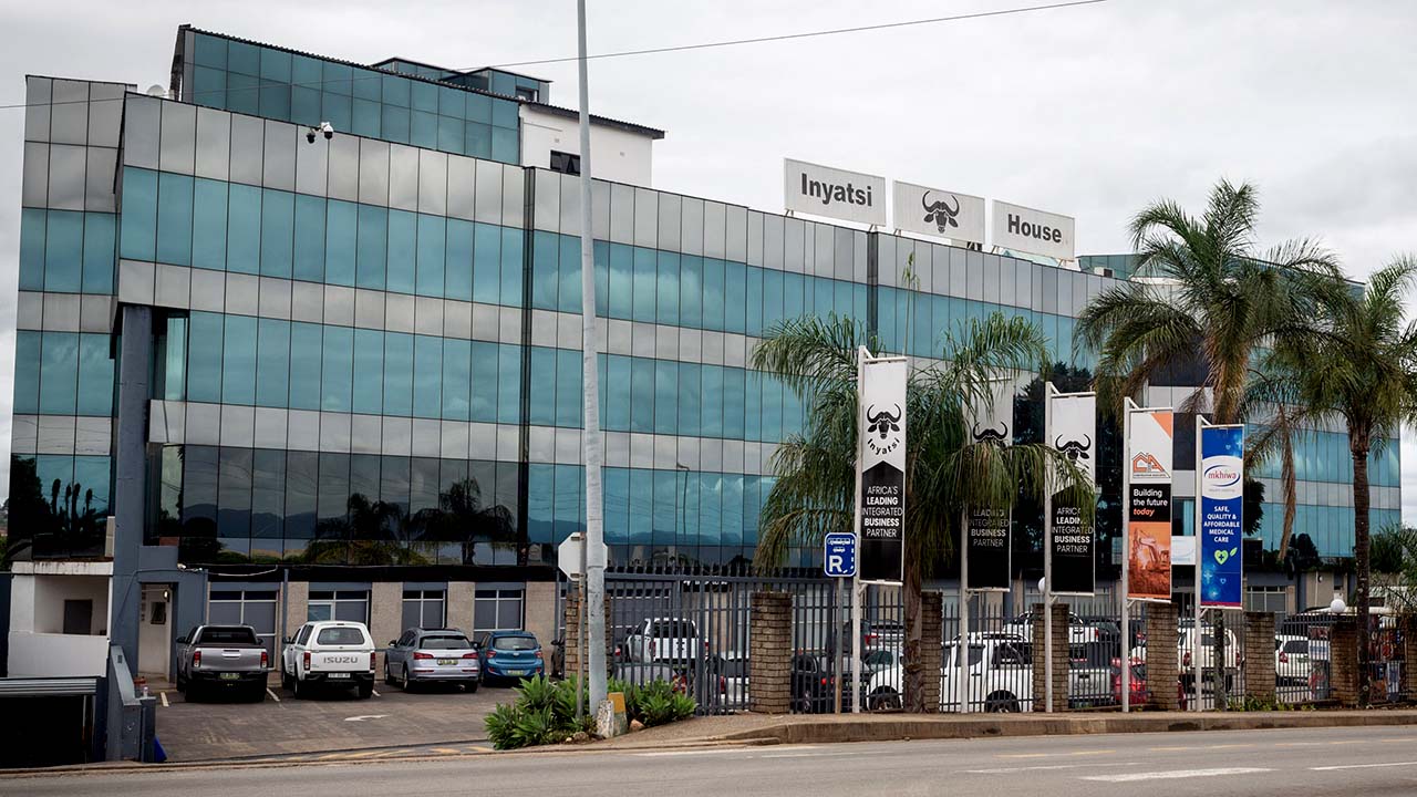 A large, glass office building with a sign on top reading Inyatsi House.