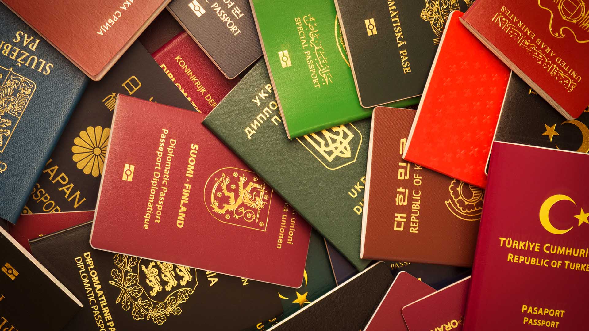 Photo of a messy pile of passports from multiple countries