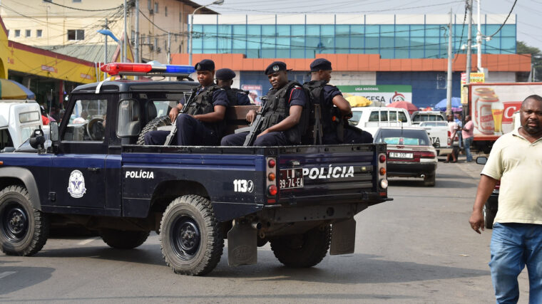 A group of heavily armed policemen in the back of a truck