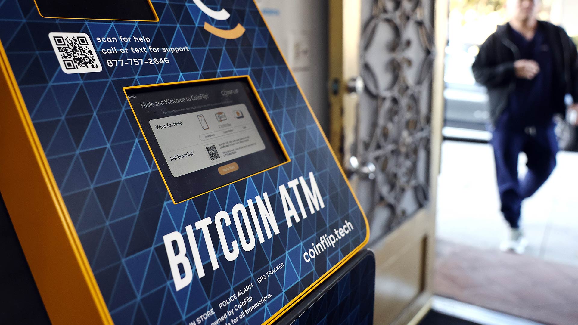 Photo of a blue CoinFlip kiosk with words reading Bitcoin ATM in a store.