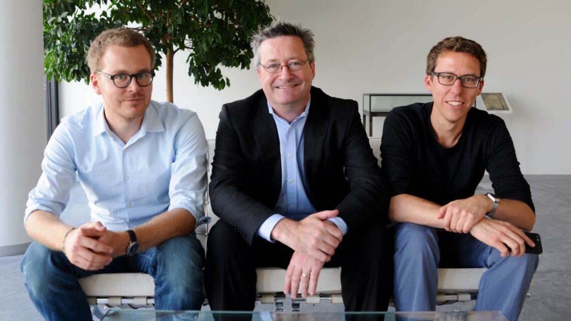 From left, Frederik Obermaier, Gerard Ryle and Bastian Obermayer sitting together on a couch.