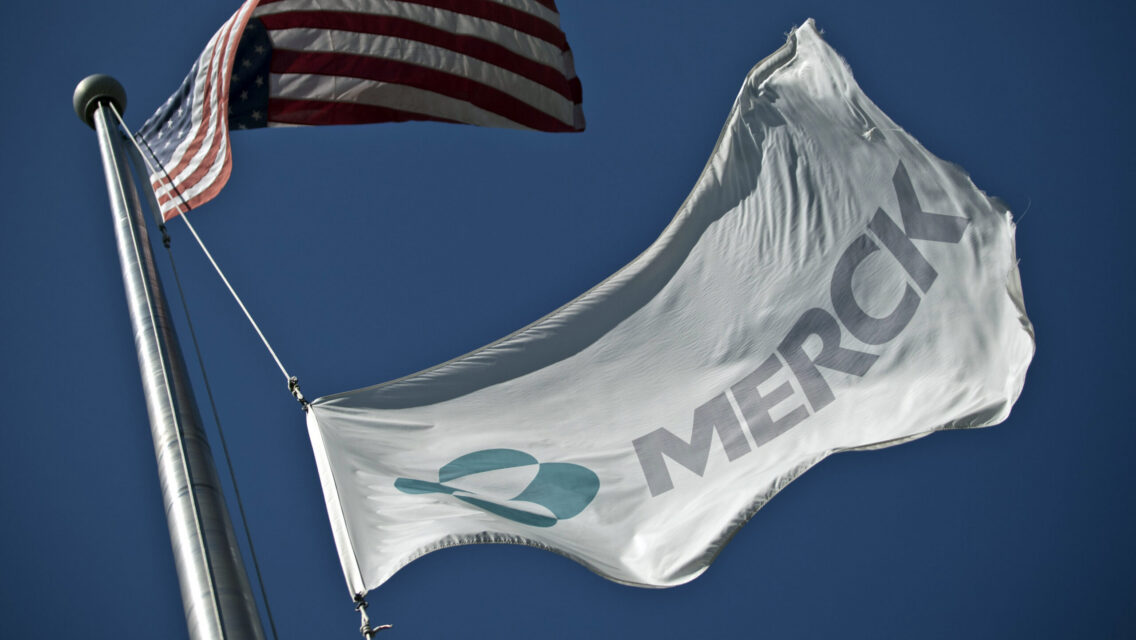 SUMMIT, NJ - OCTOBER 2: A Merck flag flies in front of the company's building on October 2, 2013 in Summit, New Jersey. The pharmaceutical company Merck & Co. announced today that it would cut 8,500 jobs and consolidate its real estate in Kenilworth, New Jersey instead of moving its headquarters to Summit as previously planned.