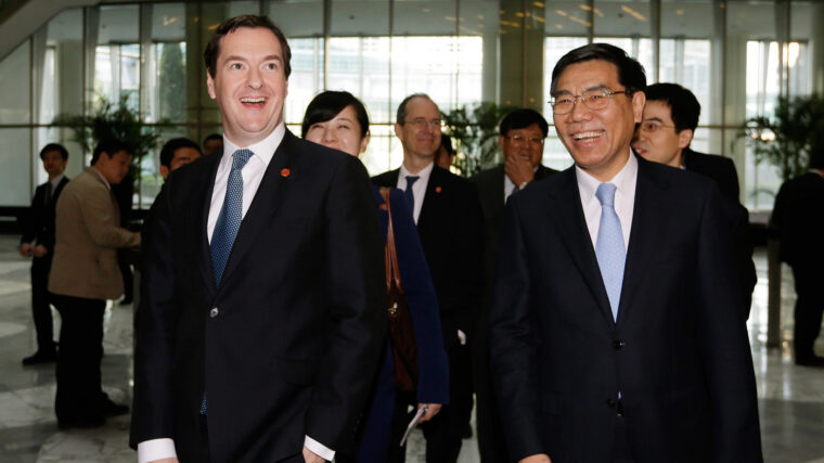 Two men in suits laughing