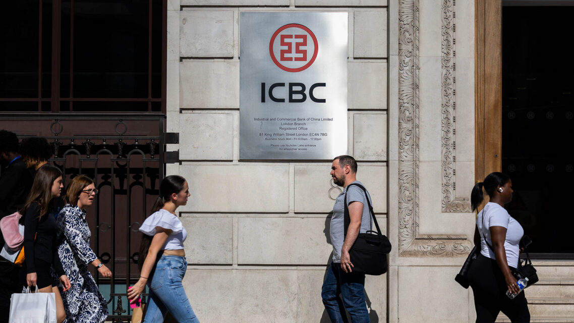 Photo of people walking past a building with a sign that reads ICBC
