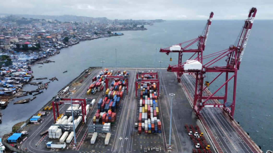 Photo of a cargo terminal from above, with cranes that read Freetown on the side